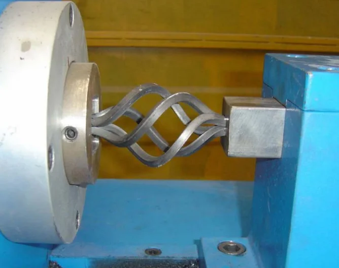 Program controlled metal bar twisting wrought iron machine