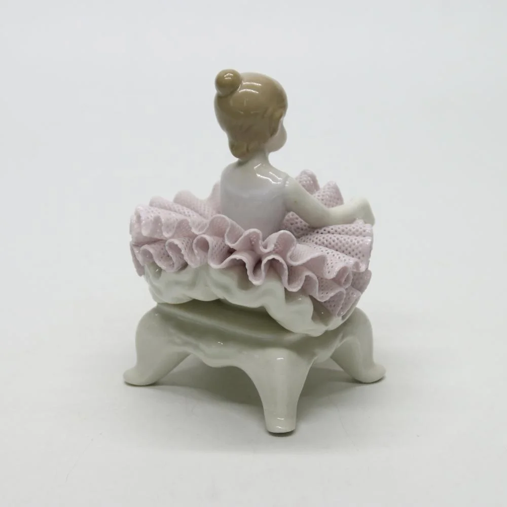 Ceramic ballerina dancer girl figurines on the chair