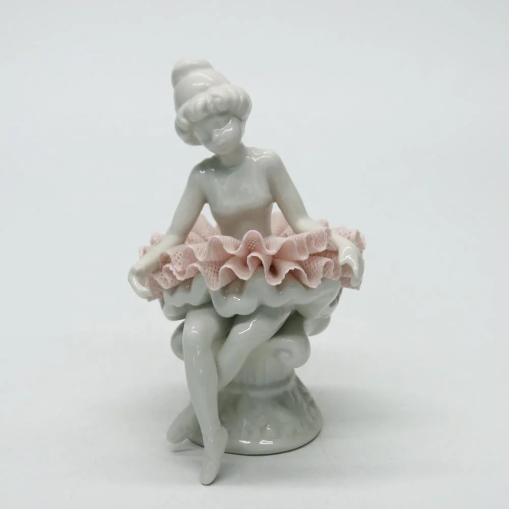 Ceramic ballerina dancer girl figurines on the chair