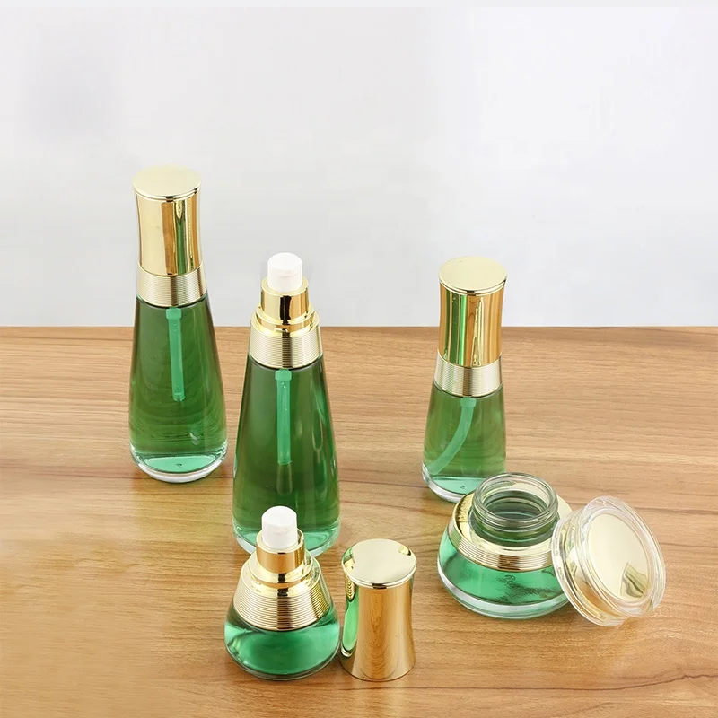 Custom cosmetic packaging transparent skin care glass bottle set with gold cap