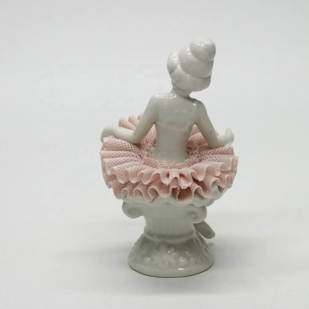Ceramic ballerina dancer girl figurines on the chair