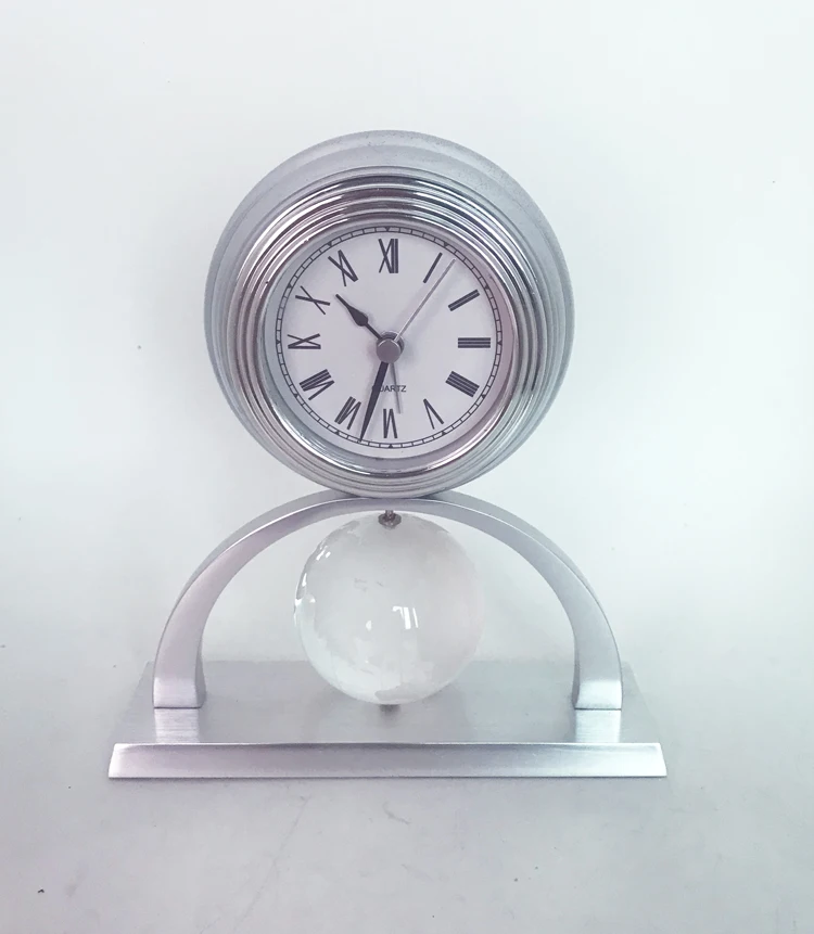 Metal pendulum clock with crystal globe