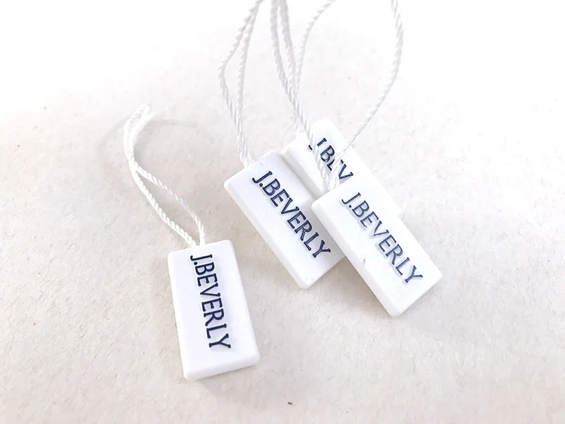Watch Hang Tags Custom Quality Embosed Logo Authentic Hologram Plastic Garment Tags with Nylon String on Two Ends White Plastic