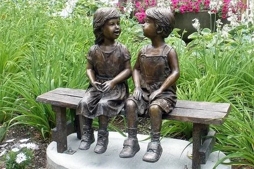 modern outdoor decoration bronze girl and boy reading on bench sculpture