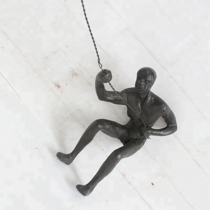 Rock climb with rope Muscular man bronze sculpture