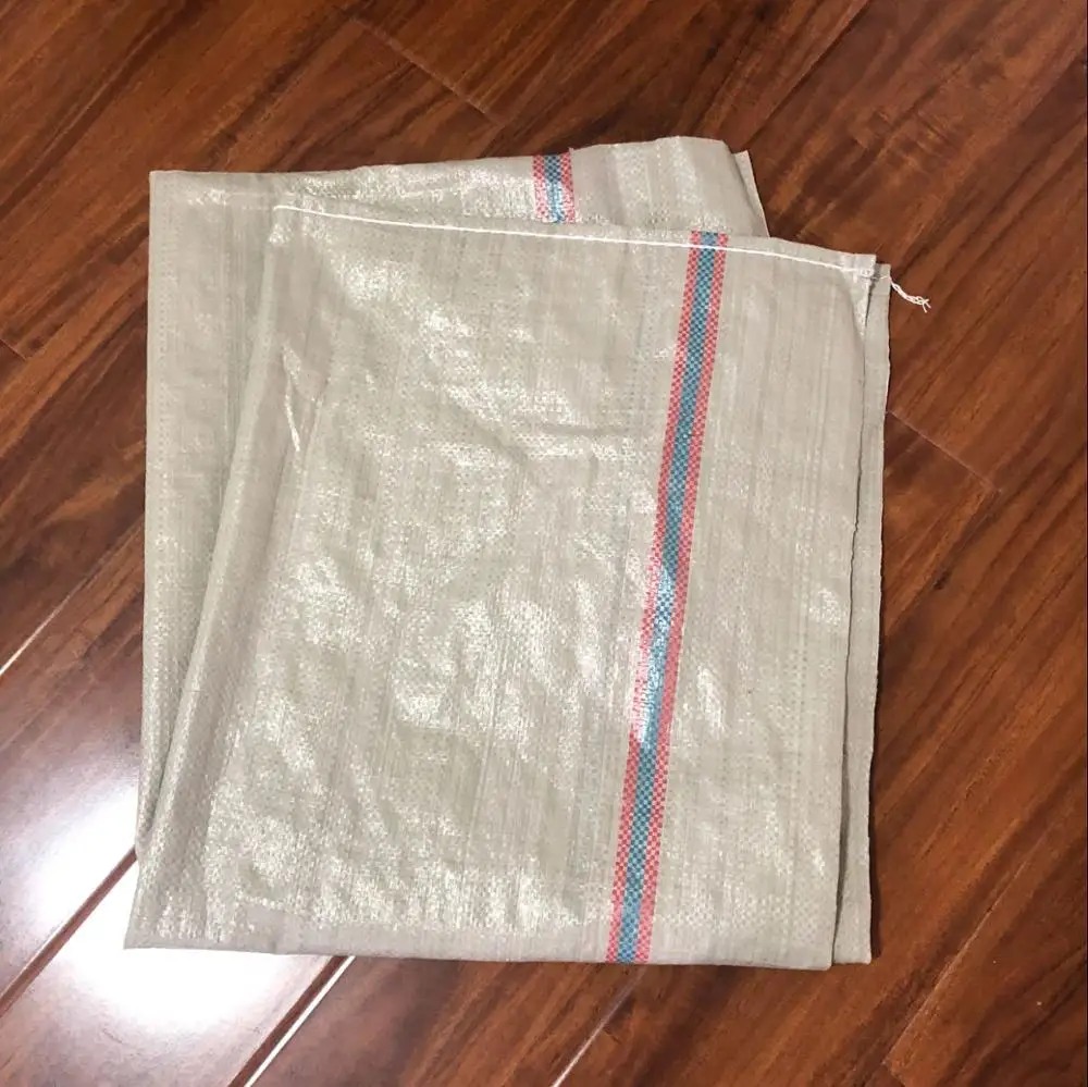 large green plastic woven sack for garbage, construction debris