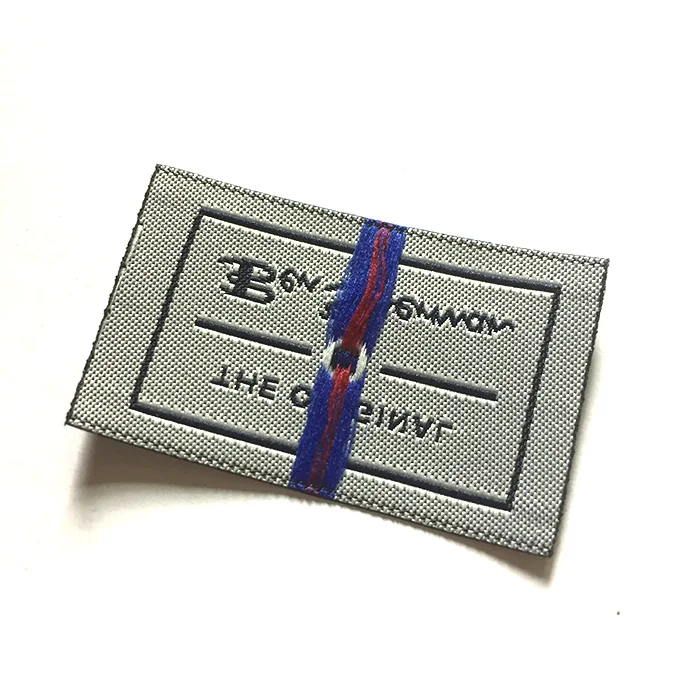 High density gold thread woven label with fold