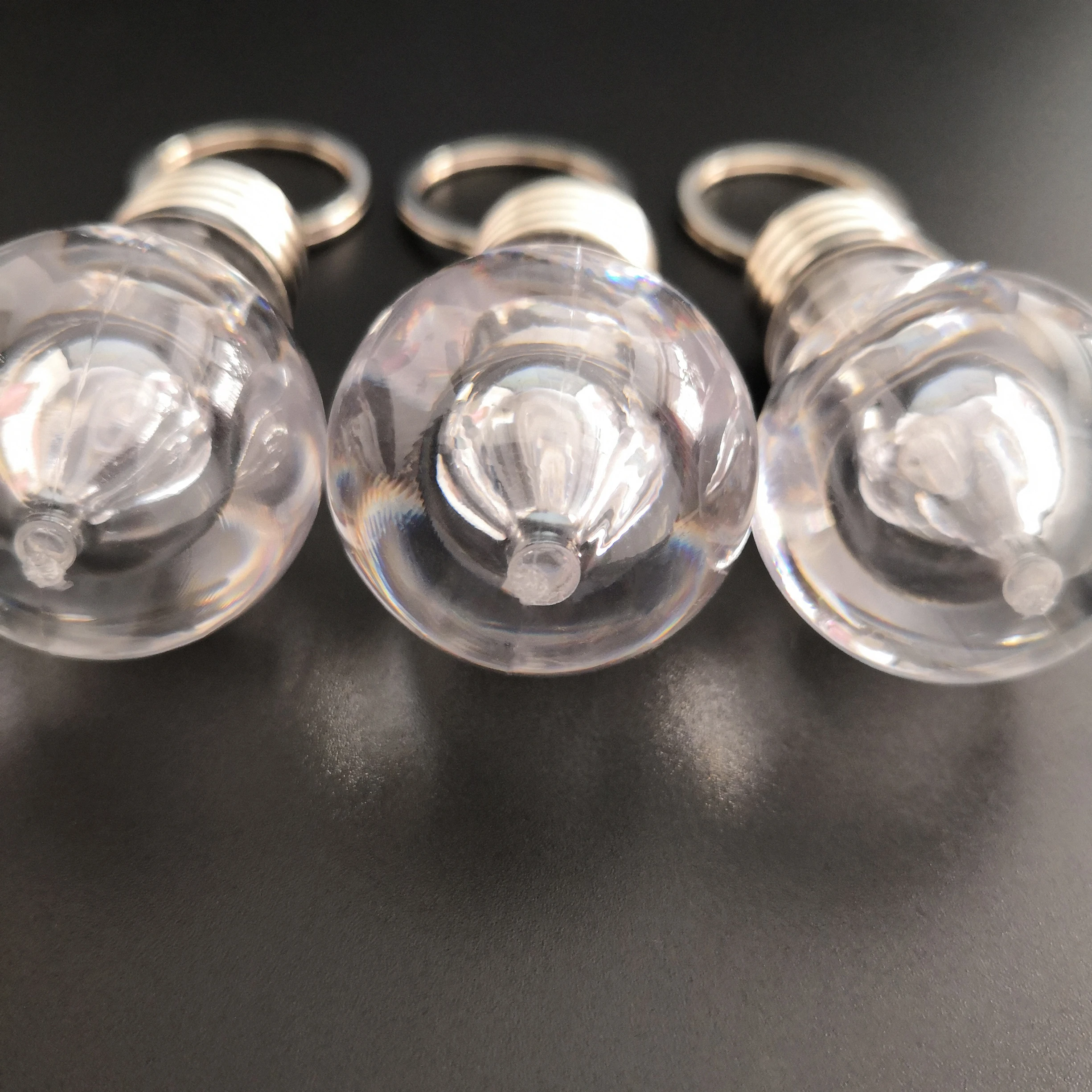 
Custom Logo Souvenir Plastic Mini Colorful Led Light Bulb Ring Keychain Cute Accesory Lovely Light Lamp Key Chain 
