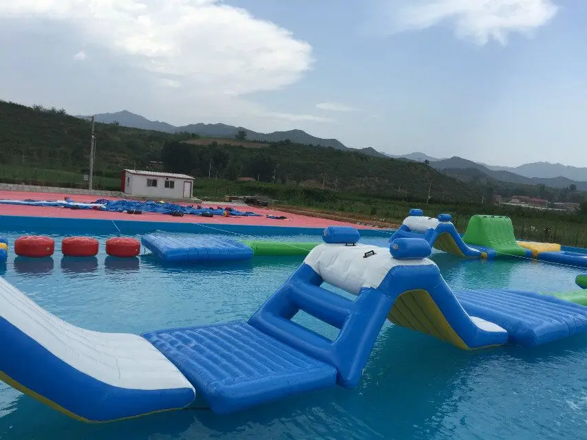 Guangzhou wholesale cheap price large inflatable water slide with steel frame swimming pool inflatable water park equipment 2018