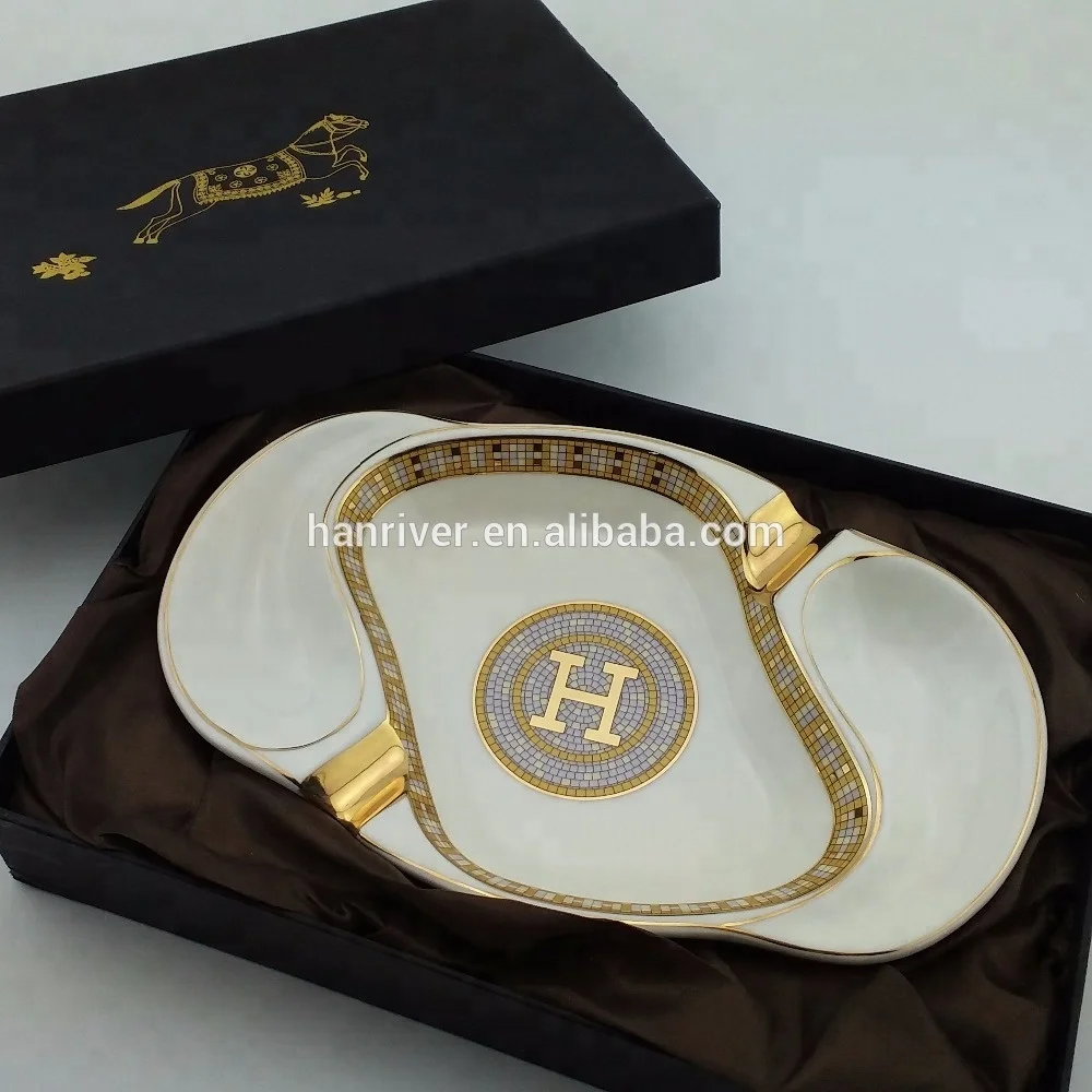 
Best selling oval ceramic ashtray with golden edge with two golden rest with customized logo for sale 