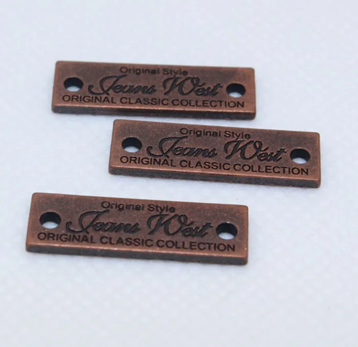 
nickle free embossed and debossed logo custom metal clothing brand labels 