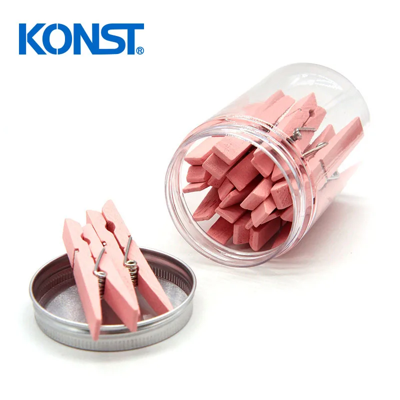 Pink wood clothes peg in plastic jar for office