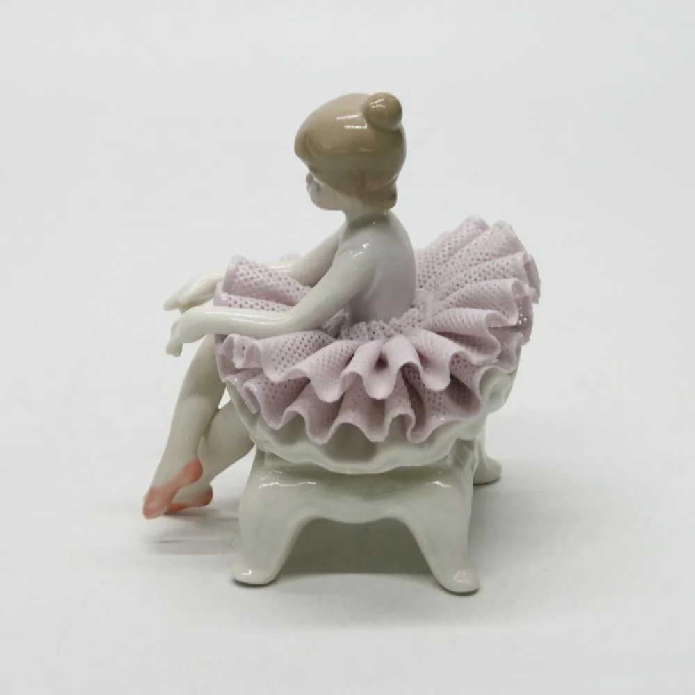 Ceramic ballerina dancer girl figurines on the chair