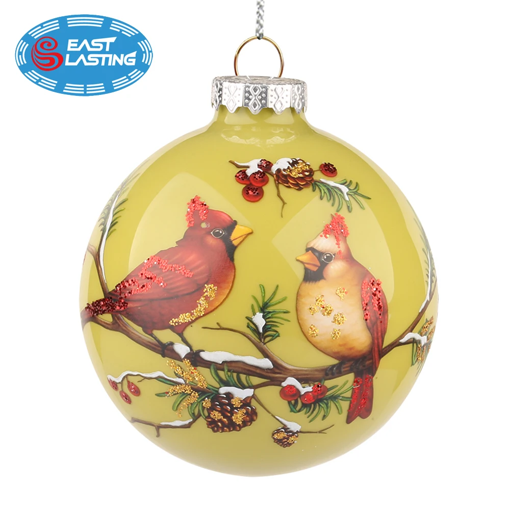 Glittered red cardinal with snow and branches glass ball Christmas tree ornament