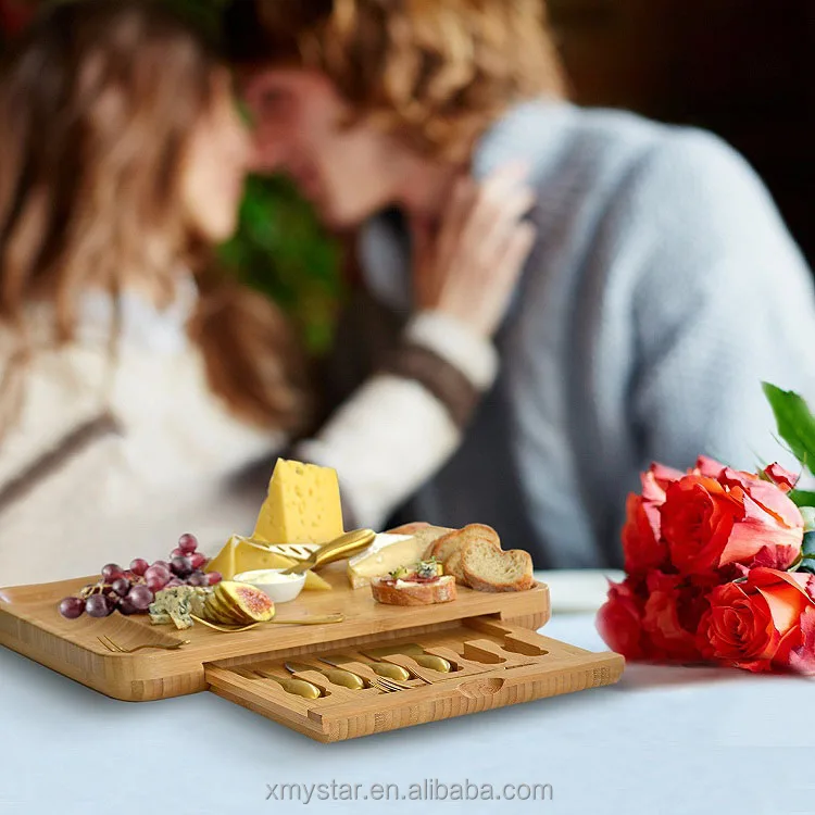 
bamboo cheese serving cutting board wooden, multipurpose servinf tray with a set of 6 cutleries in a slide-out drawer perfect fo 