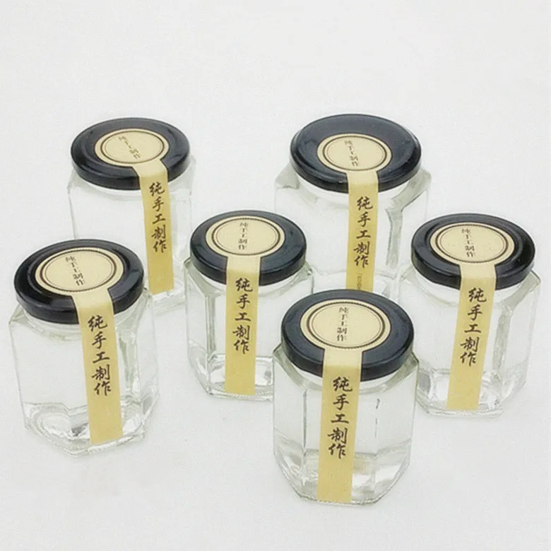 Wholesale different sizes hexagon honey glass jar glass storage bottle with black screw metal lid