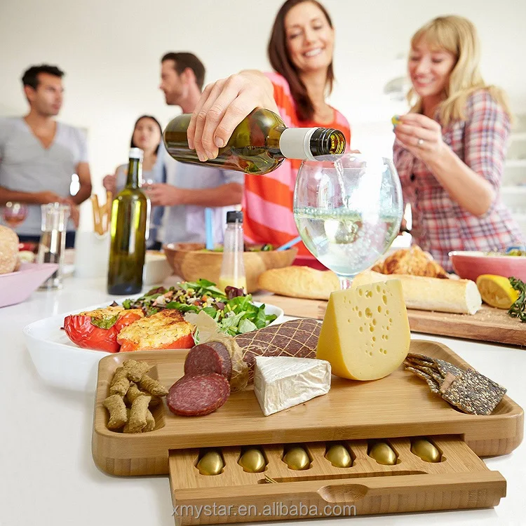 
bamboo cheese serving cutting board wooden, multipurpose servinf tray with a set of 6 cutleries in a slide-out drawer perfect fo 