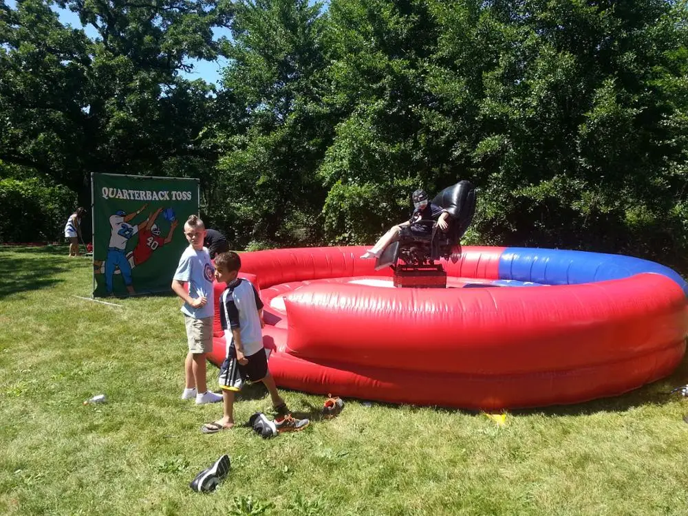 Giant Mechanical Rodeo Bull With Inflatable Mattress Interactive Game In Amusement Park