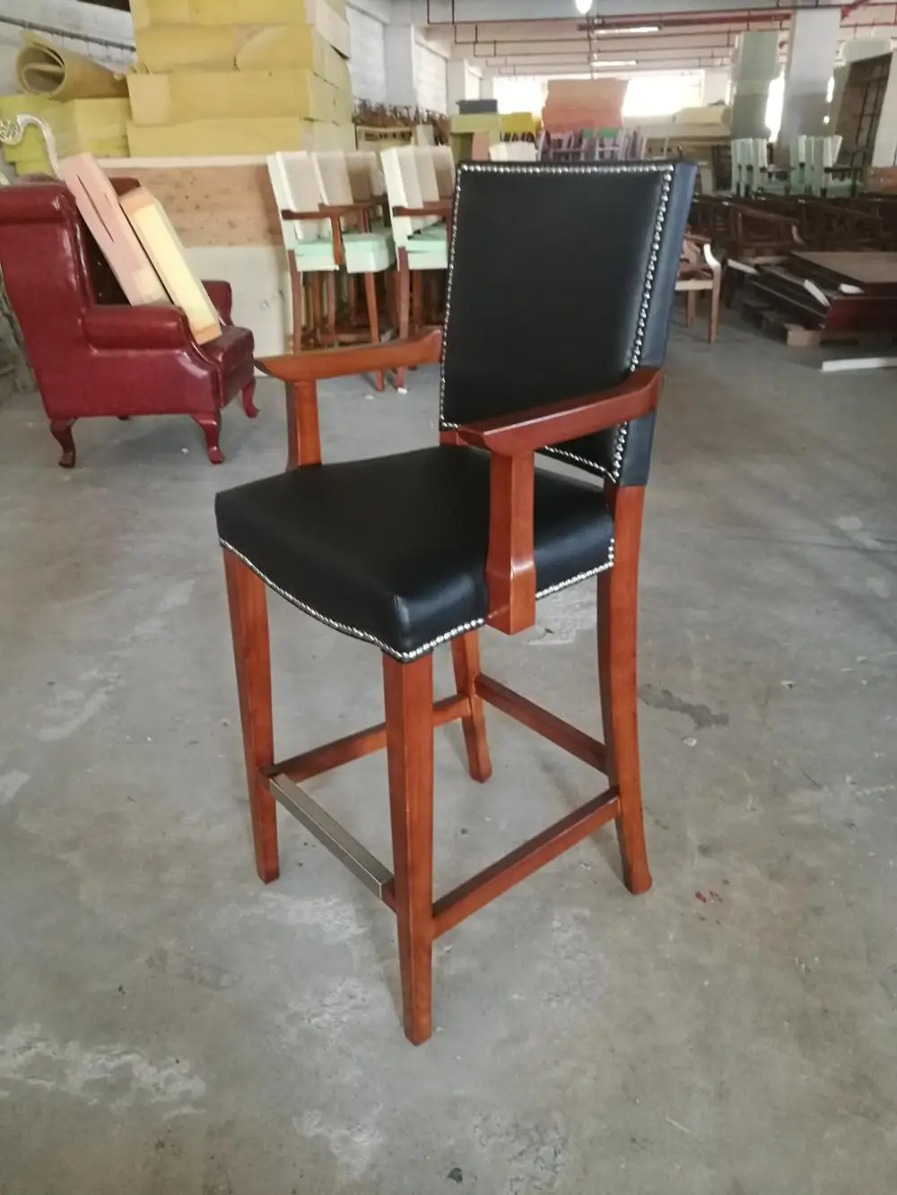 Durable black leather bar stool with armrest