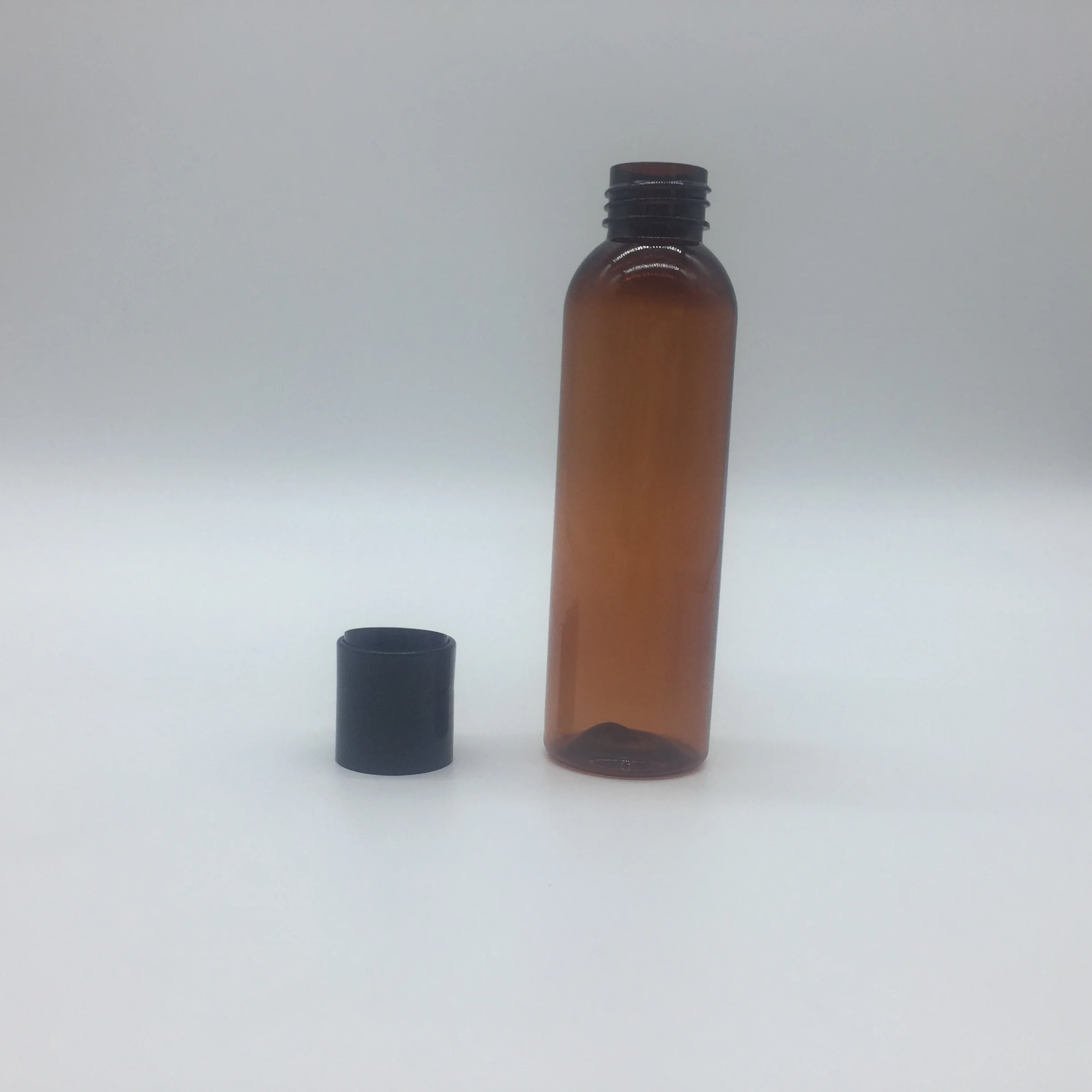 
4OZ amber cosmo round PET bottle with disc top cap 
