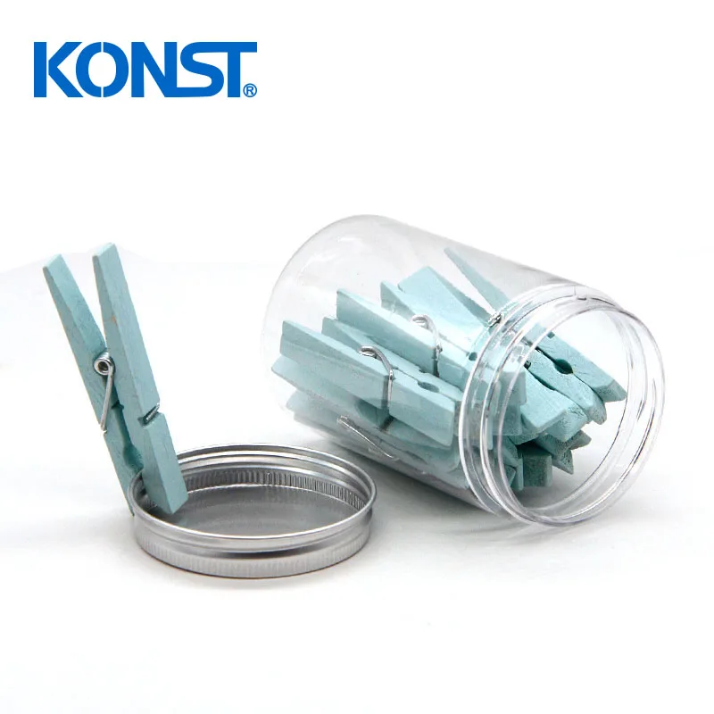 Pink wood clothes peg in plastic jar for office