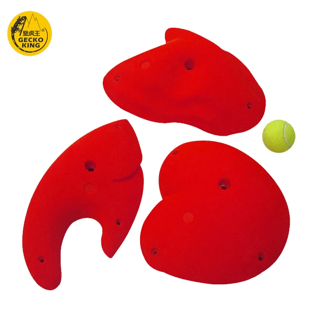 Adult climbers climb rock climbing holds jugs for indoor