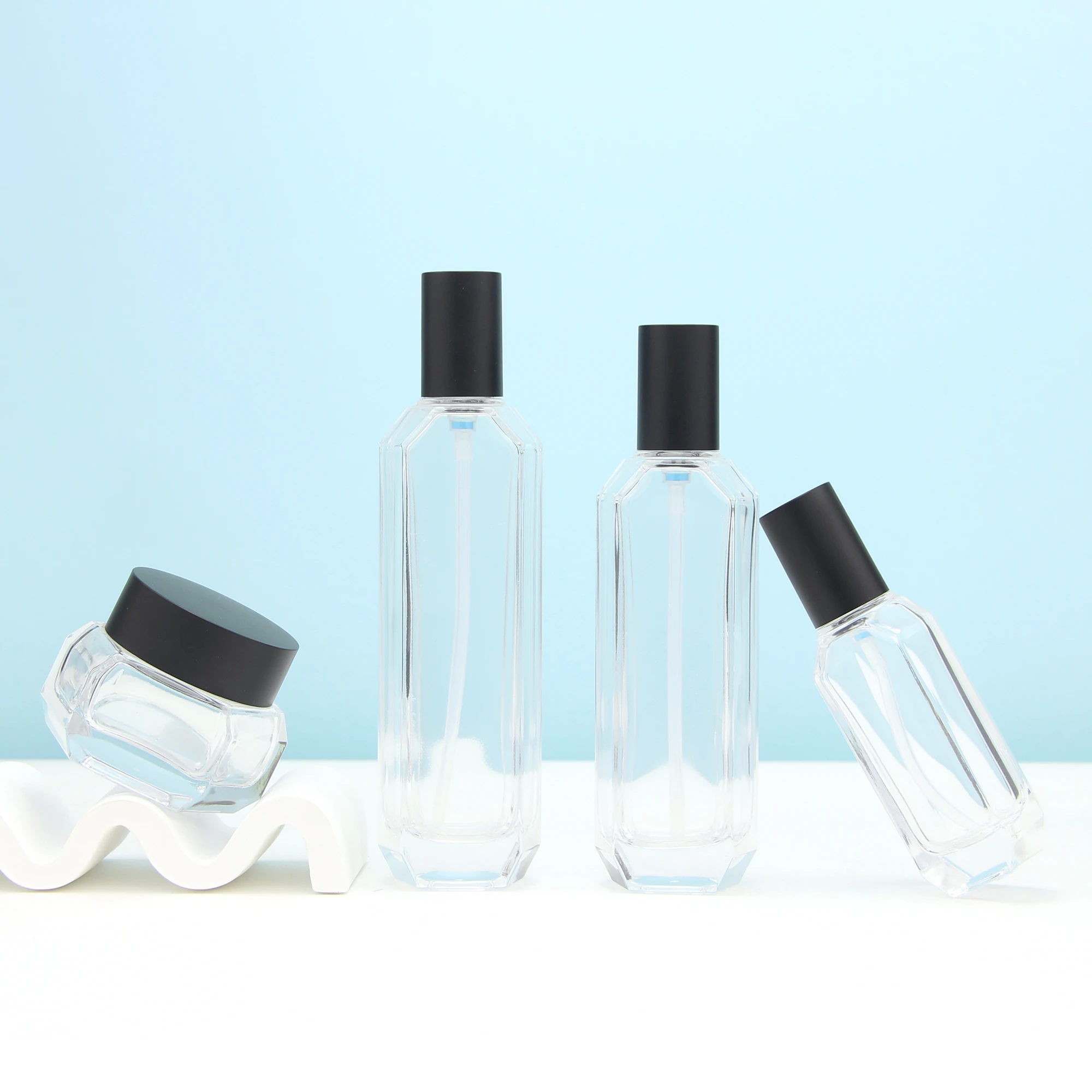 Guangzhou supplier transparent cosmetic series glass lotion pump bottle and facial cream jar with black cap