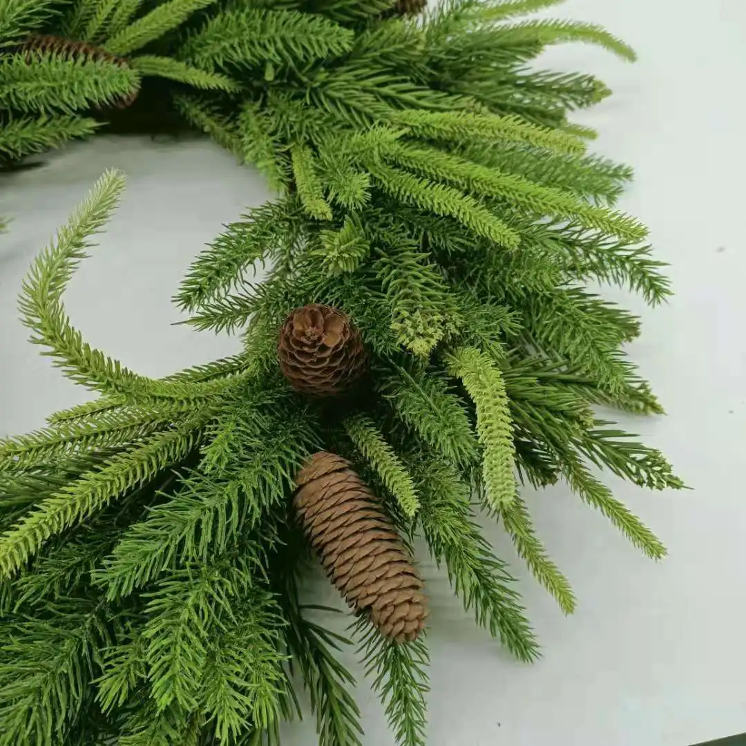 Artificial pine needles and pinecone wreath for Christmas