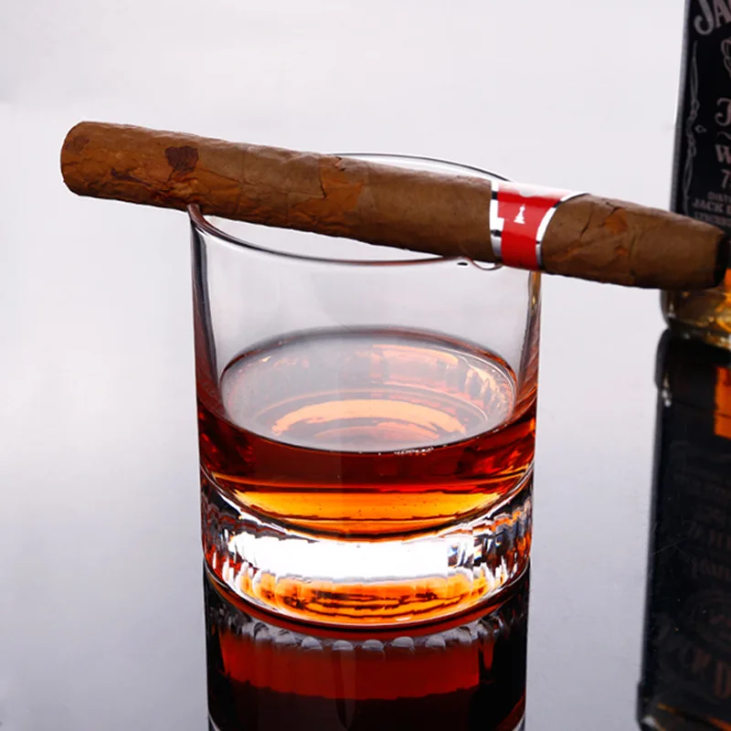 Cigar holding whiskey glass