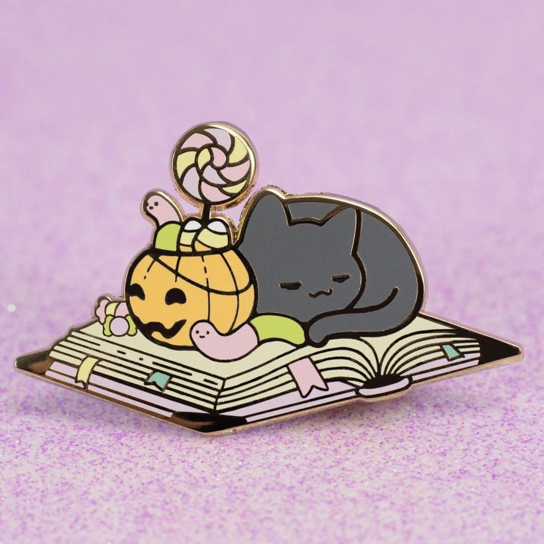 Sleepy candy cat laying on the book enamel lapel pin badge custom pumpkin Halloween gifts hard enamel pins