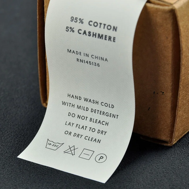 Garment clothes main tag wash label tape tear away by hands