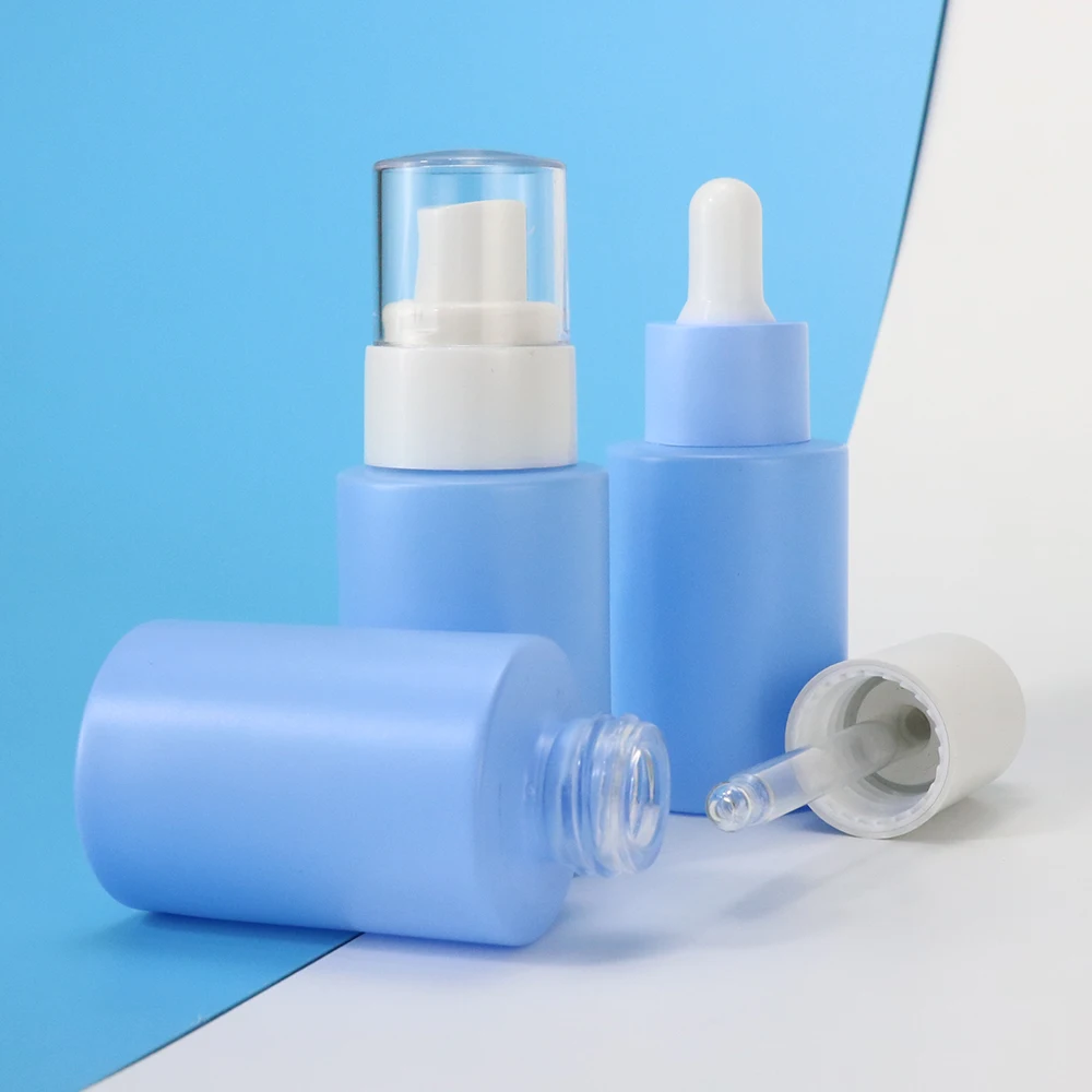 Pink blue cosmetic glass bottles and jars 50g 40ml 120ml skincare line with pump silver top for serum oil liquid cream packaging