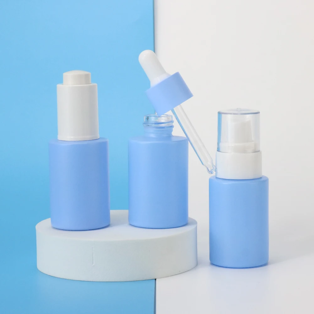 Wholesale 1oz empty blue round skin care glass bottle packaging cosmetic body oil bottle lotion bottle with pump cap 30ml