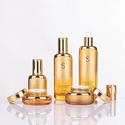 Luxury BaoMo China Glass Factory skin care packaging gold cosmetic glass cream jars and pump bottles