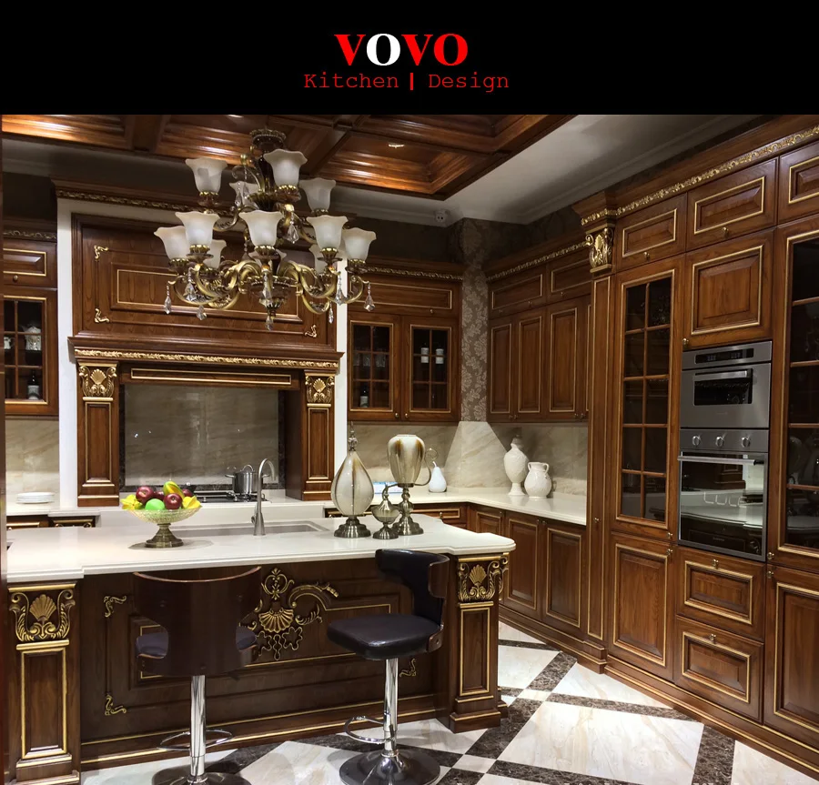 Кухонный шкаф темного цвета из массива дерева с золотой росписью