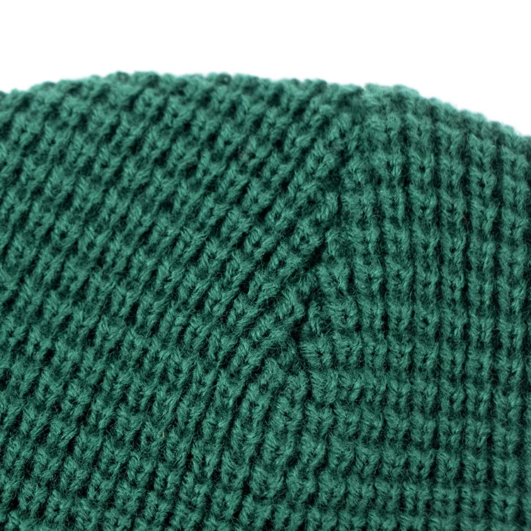 Hengxing solid green color custom pvc rubber patch skull cap soft cuffed winter warm hat waffle knit beanie manufacturer