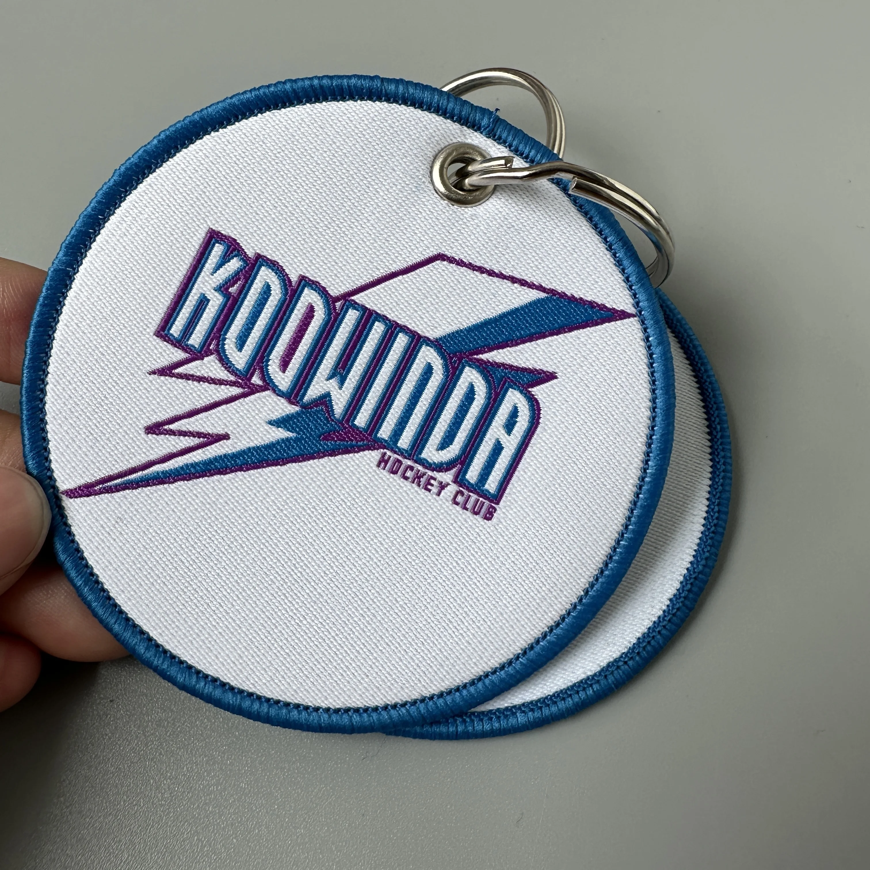 Wholesale customized remove luggage tag label before embroidery keyring flight for logo woven keychains