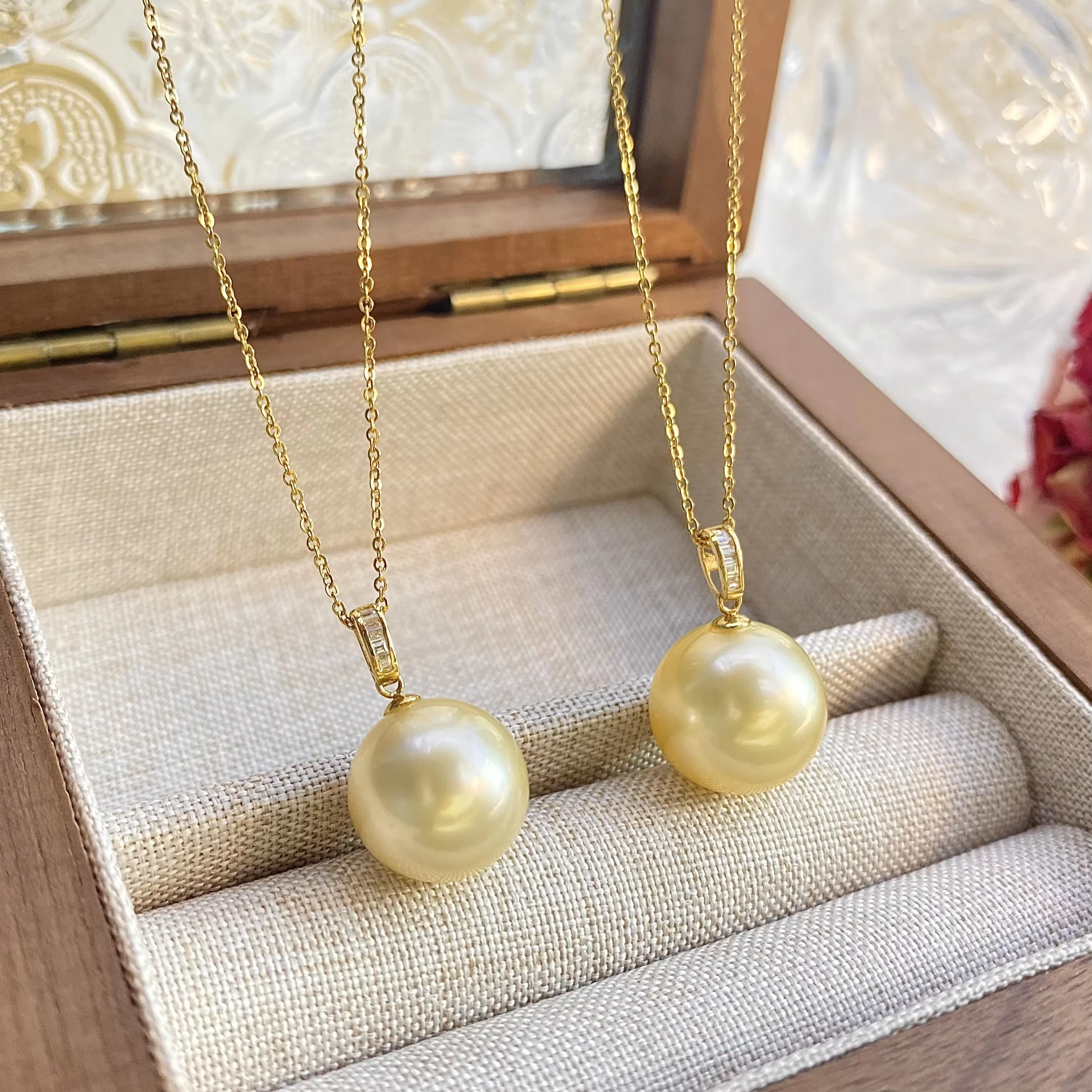 Seawater pearls are round and slightly defective. Nanyang Golden Bead Pendant is 14mm 18K gold.