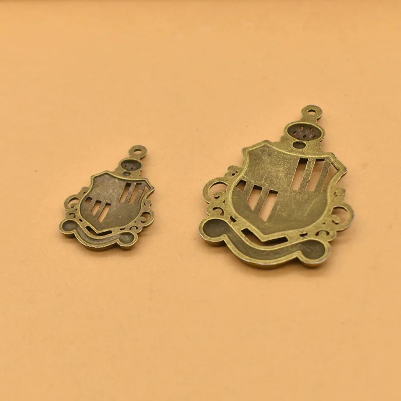 Unique and charming vintage style! Beautifully hollowed alloy crown pendant, badge, to complement your accessories!