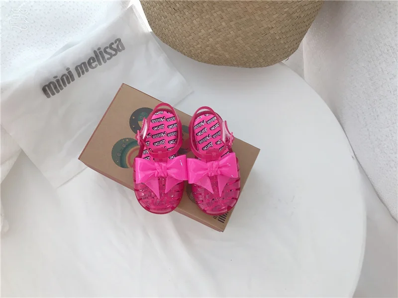 2023 mini Melissa shoes kid bowknot hollow out sandal jelly baby wrap toe soft sole beach wear resistant skid shoes