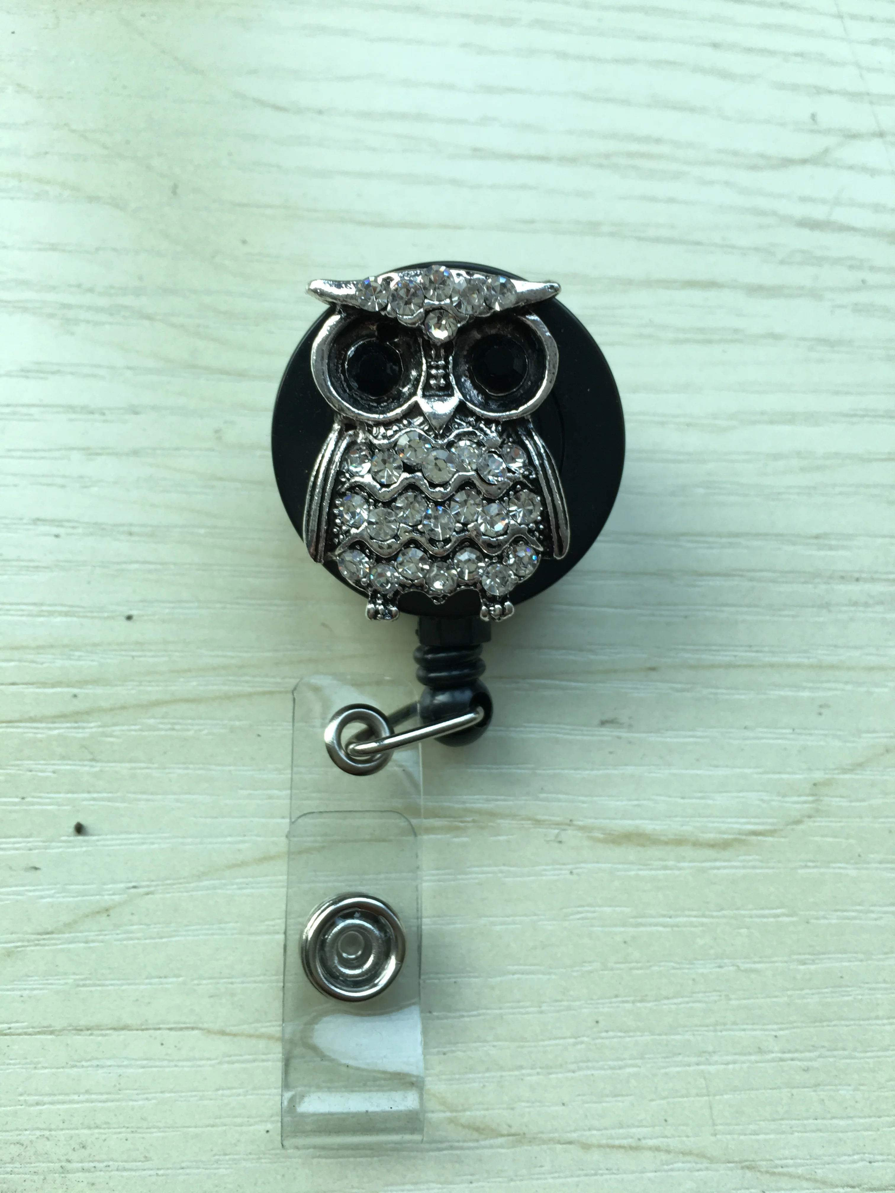 Retractable reel badge with breast cancer awareness logo