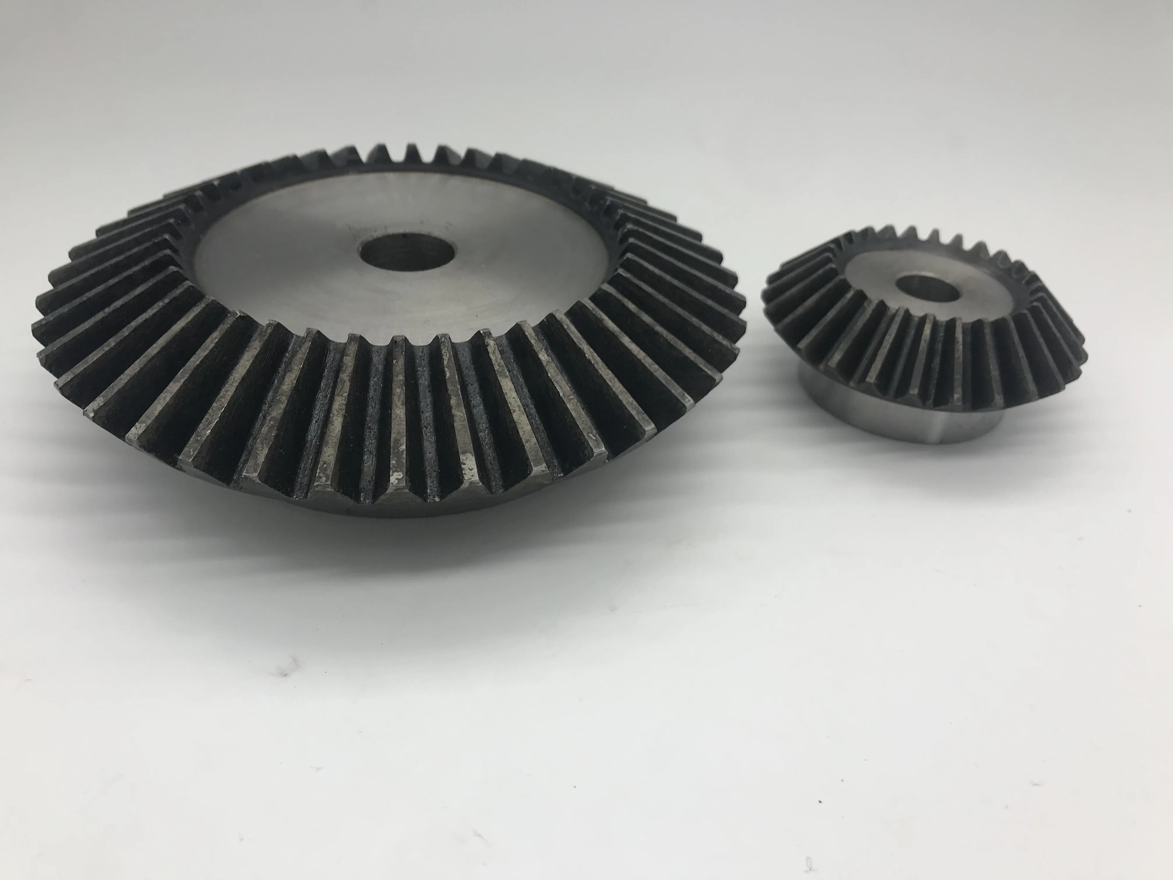 
High strength and low cost bevel spur gear, forging process hardened teeth for baler 