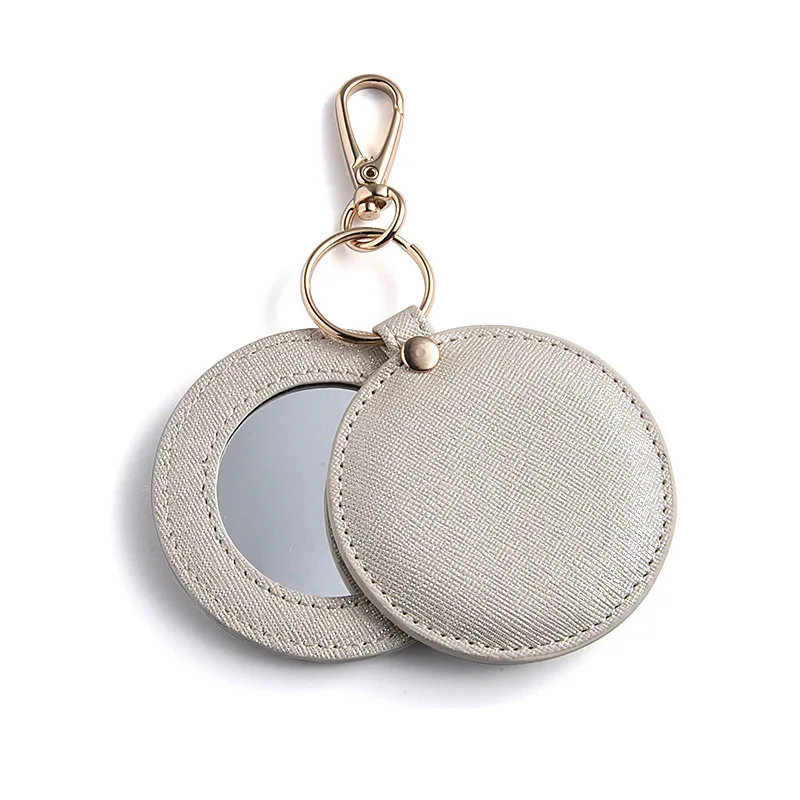 CCustom Logo PU Leather Heart Shape Cute Small Portable Mini Cosmetic Compact Pocket Mirror Keychain Mirror For Makeup