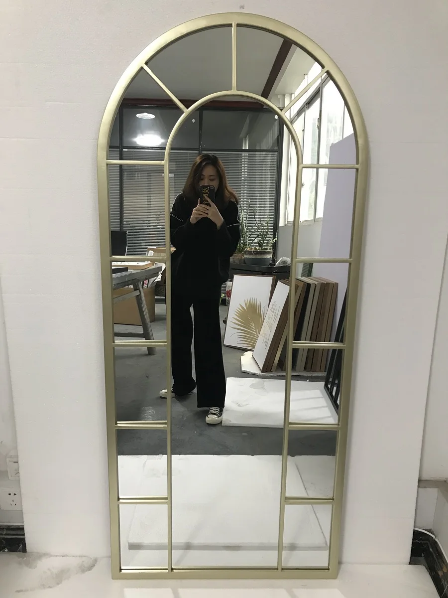large arched full-length metal floor standing dressing mirror