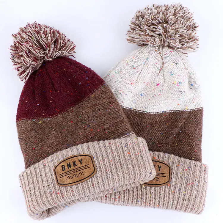 Qianzun manufacturer custom winter chunky speckle yarn block cuff pom pom beanie with leather patch