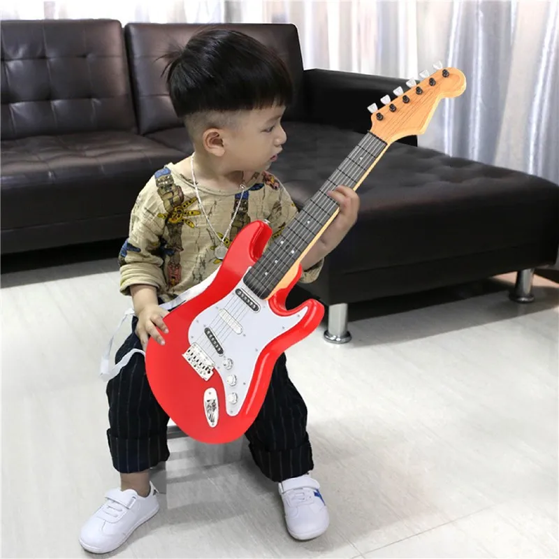 Children learn their first electronic guitar toy