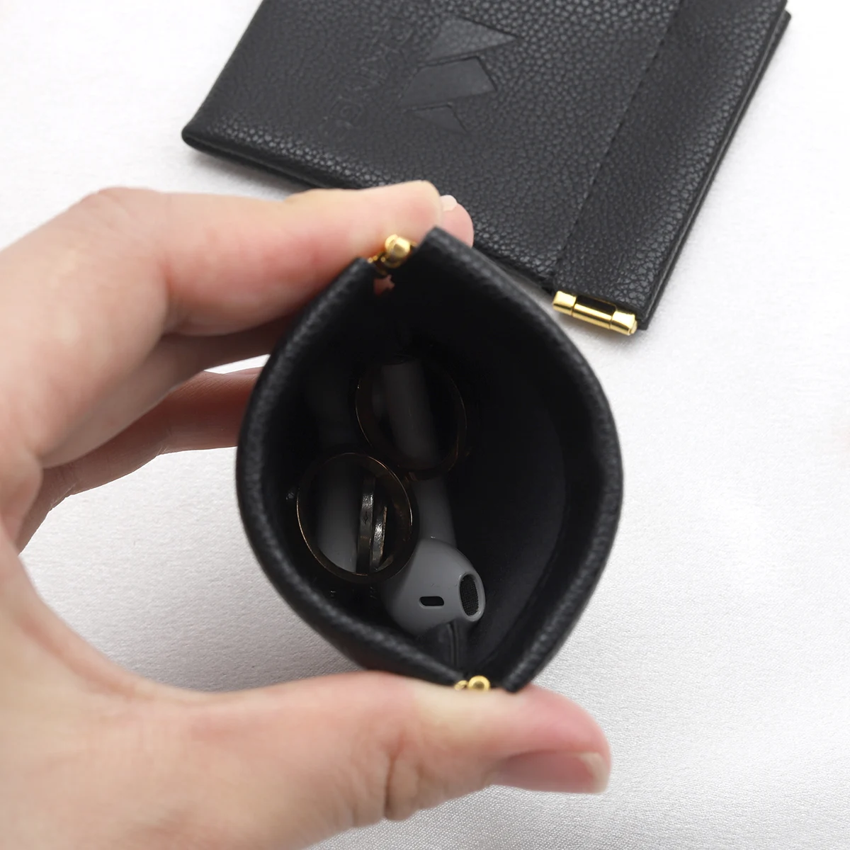 Custom Emboss Logo Reusable PU Leather Black Bag For Bluetooth Headset Packaging Shrapnel Openings Leather Dust Pouch