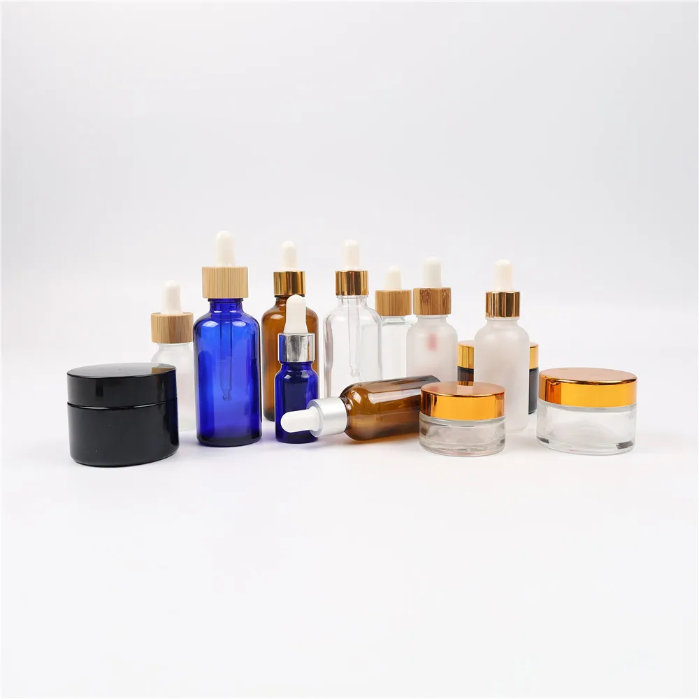 Empty 30ml 60ml custom glass essential oil bottles luxury 2oz cosmetic glass containers hair oil serum dropper bottle clear