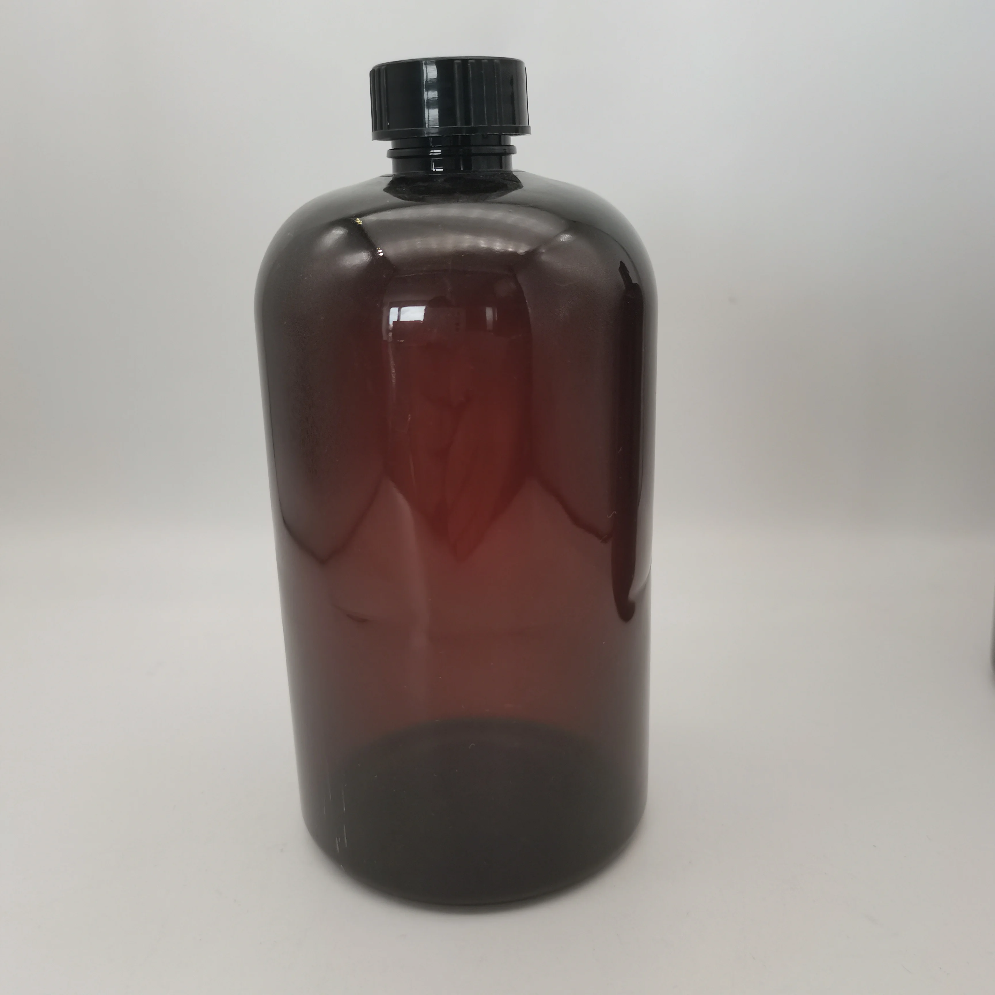 Dark amber Boston plastic bottle with black screw top and top