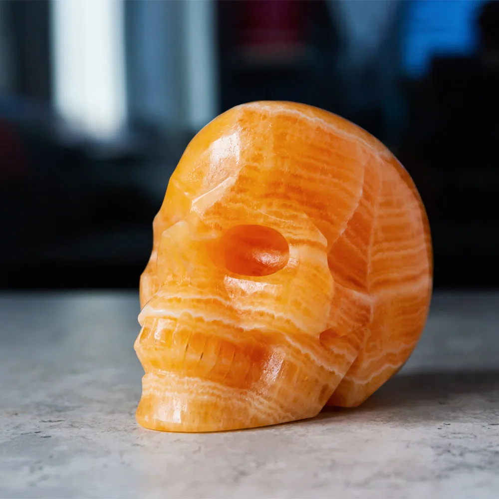 Wholesale Natural Reiki Gemstone Hand Carved Orange Calcite Crystal Skulls Crafts Healing Stone For Home Decoration